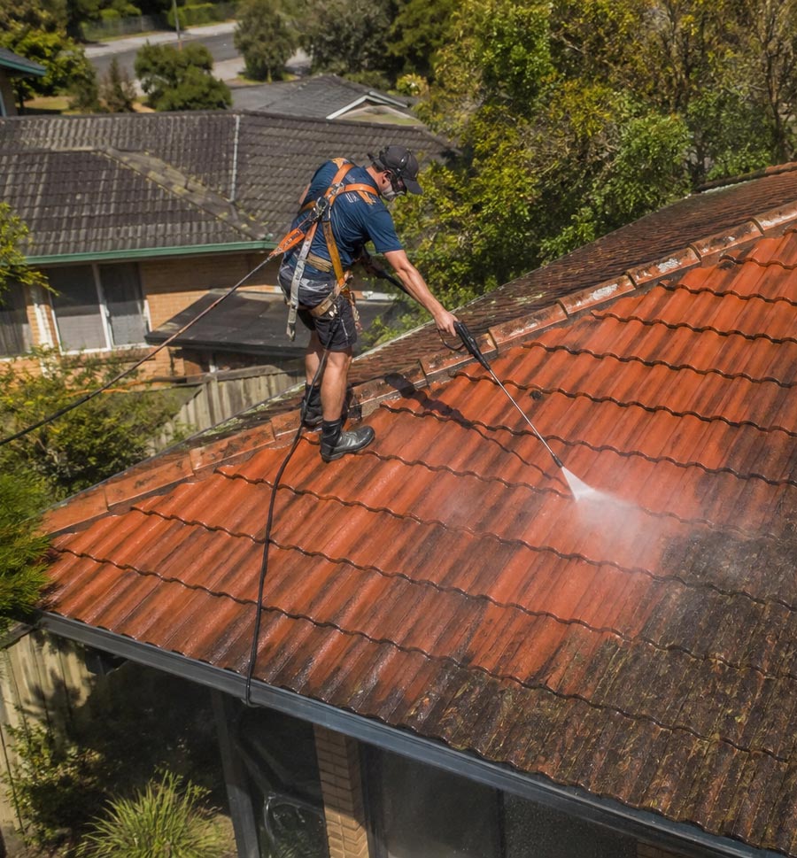 Goshen Roof Restoration team applying protective coating